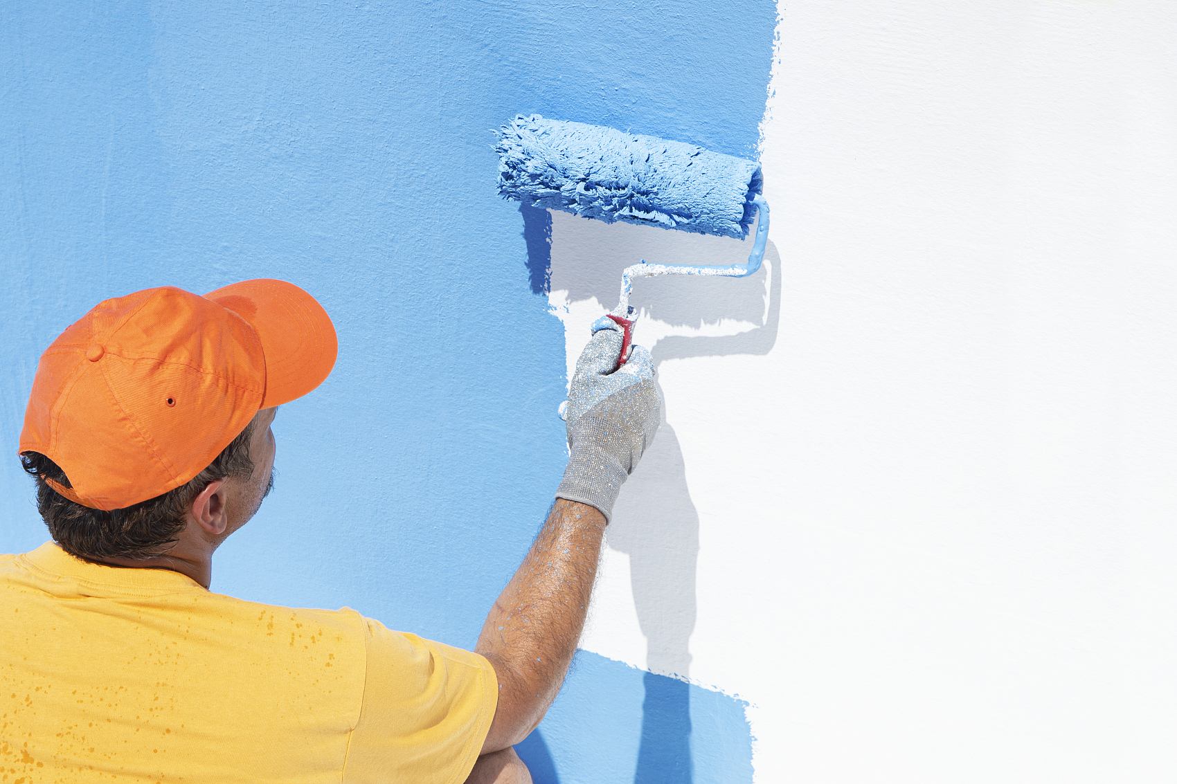 Exterior wall coating application scene.