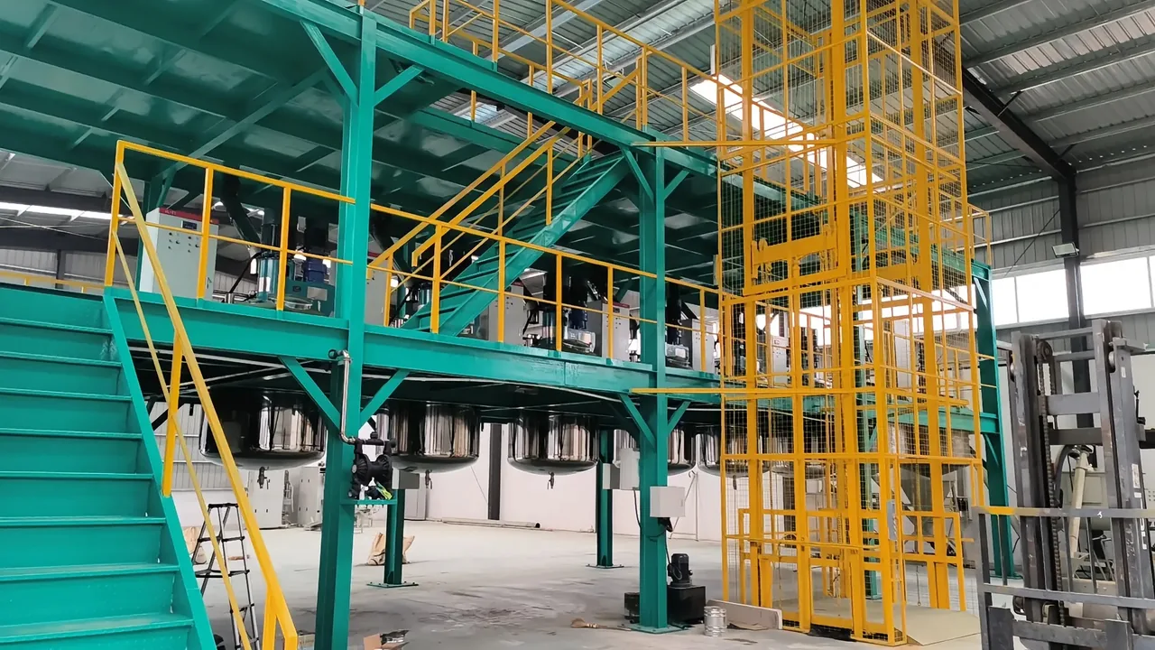 Coatings production equipment, storage tanks, and a material lift