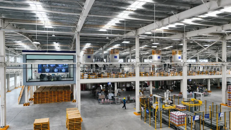Automated paint production workshop with mixing, filling, and palletizing equipment