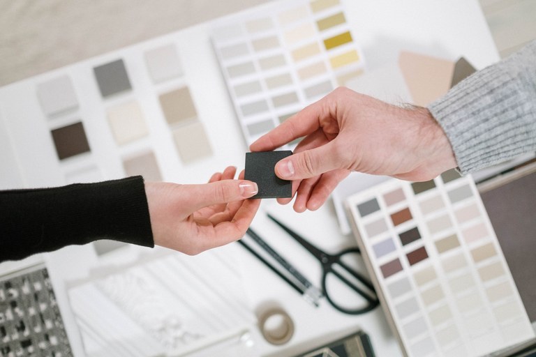 Color-sample review in a general material discussion setting.